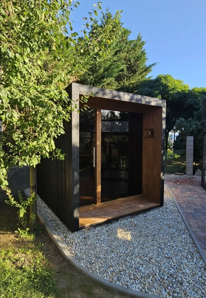 Outdoor sauna in a wooden alcove