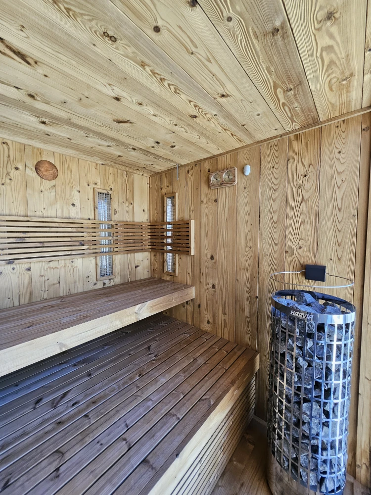 Outdoor sauna in a wooden alcove