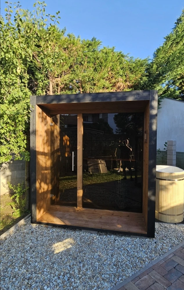 Outdoor sauna in a wooden alcove